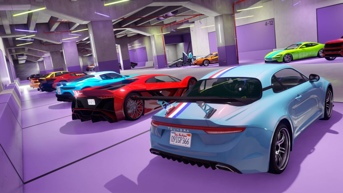 Screenshot of a warehouse full of supercars in the Vinewood Club Garage, available to GTA Plus members.