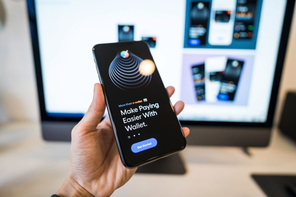 Hand holding a smartphone with a digital wallet app open, used for fast casino withdrawals