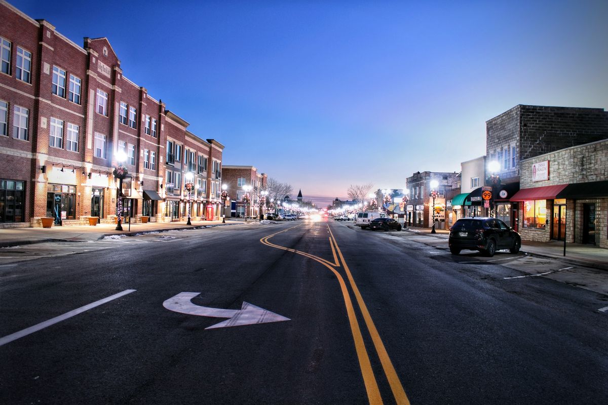 Main Street in a small US town at twilight, where sweepstakes casino access depends on state law