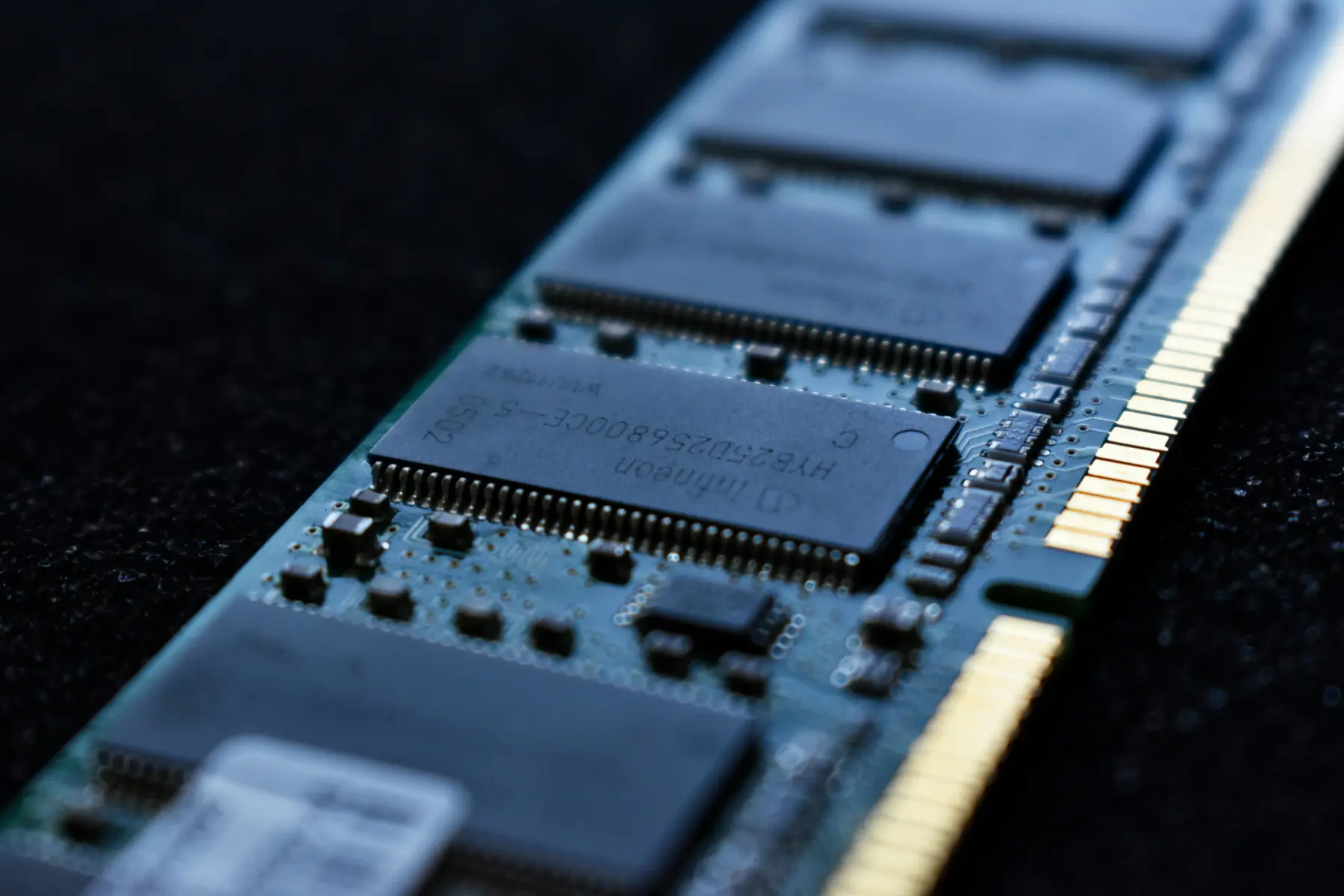 Macro view of RAM memory chips on a green computer circuit board