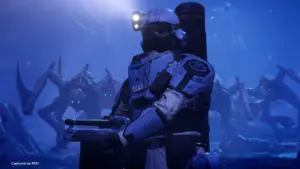 A Helldiver soldier in armor holding a weapon, surrounded by alien creatures in a dark, blue-lit environment.