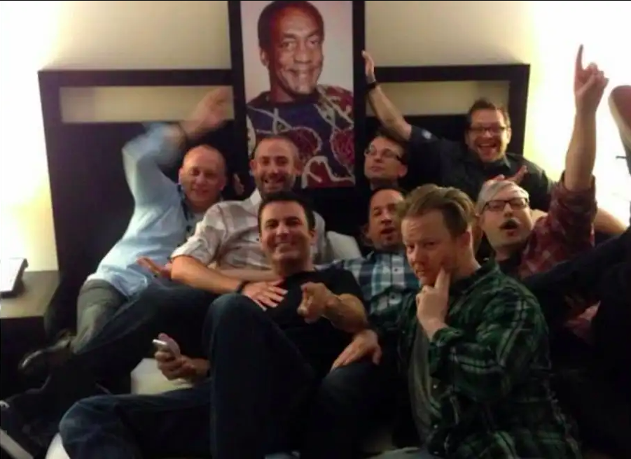 Activision Blizzard executives gather in front of a portrait of Bill Cosby in the infamous 'Cosby suite'