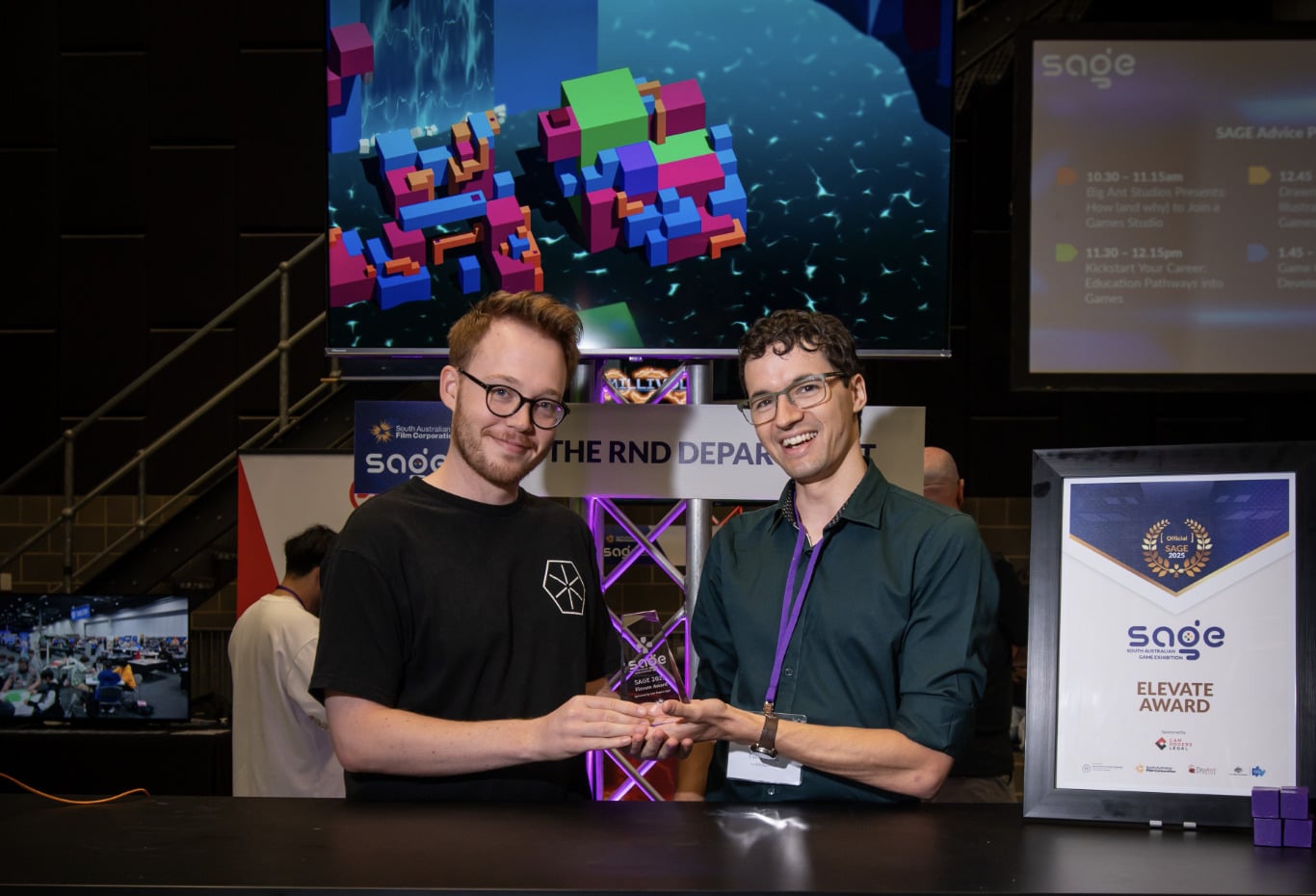 CUBE developers winning an award at SAGE 2025