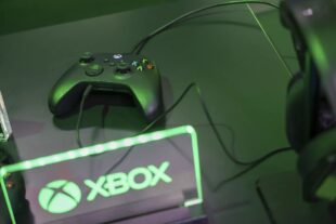 Xbox console next to the Xbox logo