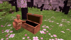 A Copper Golem standing next to a chest, soon to be introduced in the Minecraft Copper Update.