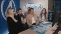 Fantastic Four: First Steps Cast plays Marvel Rivals with Australian Streamer. The picture includes actors Pedro Pascal, Vanessa Kirby, Joseph Quinn, Ebon Moss-Bachrach, and streamer LoserFruit. They are huddled around a computer setup playing Marvel Rivals, with the background decorated to promote Fantastic Four: First Steps.